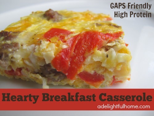 Image of a serving of an egg casserole on a white plate. Text overlay says, "Hearty Breakfast Casserole".