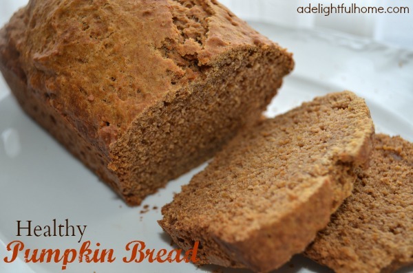 Close up image of a loaf of sliced pumpkin bread served on a white platter. Text overlay says, "Healthy Pumpkin Bread".