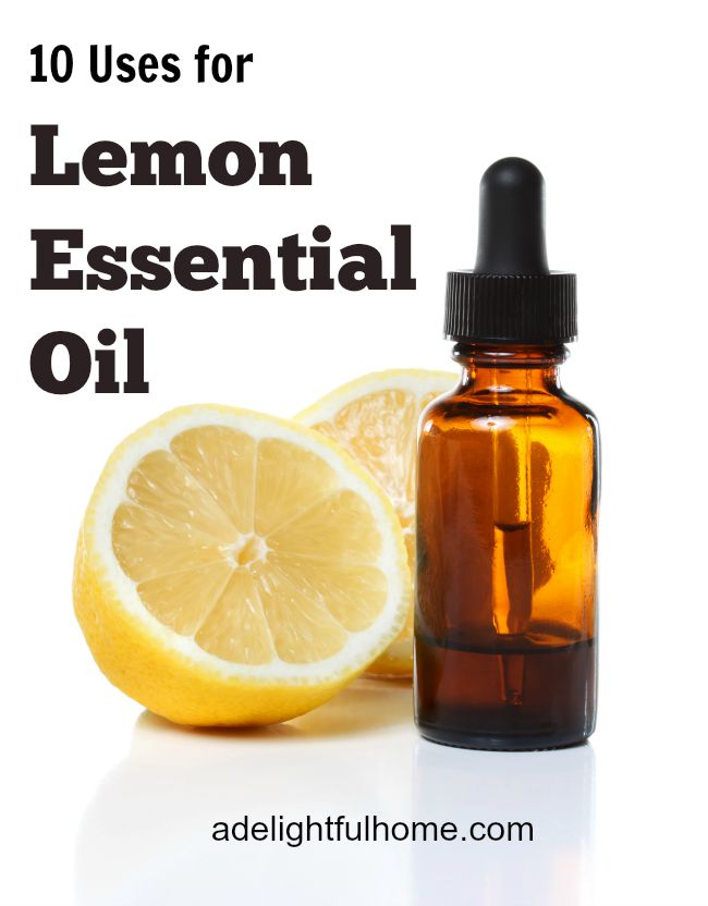 A fresh lemon cut in half sitting next to an amber dropper bottle. Text overlay says, "Lemon Essential Oil".