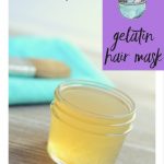 Close up of a 4 ounce Mason jar filled with a homemade hair mask with an application brush sitting in the background. Text overlay says,"How to Make a Gelatin Hair Mask".