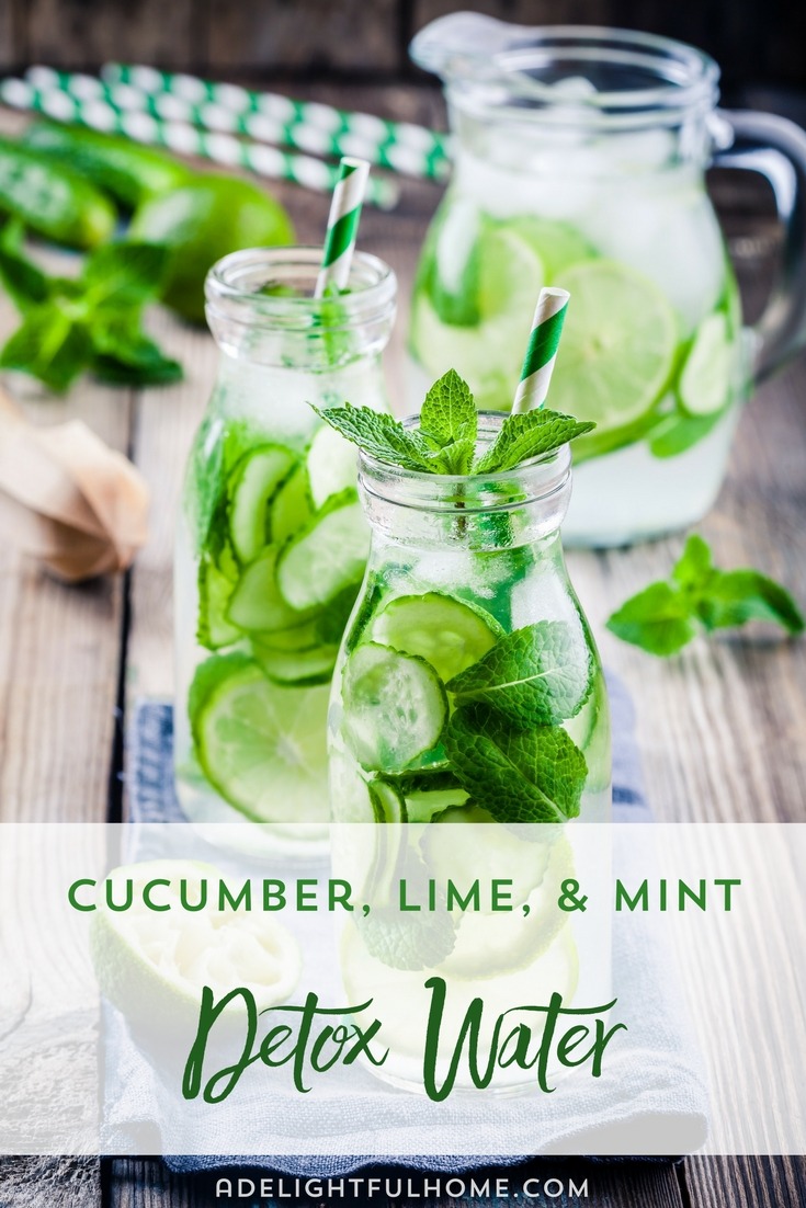 Image of glass bottles filled with water infused with cucumber and lime slices, and garnished with mint leaves, and a decorative straw. A pitcher filled with more infused water sits in the background. Text overlay says, "Cucumber, Lime, & Mint Detox Water".