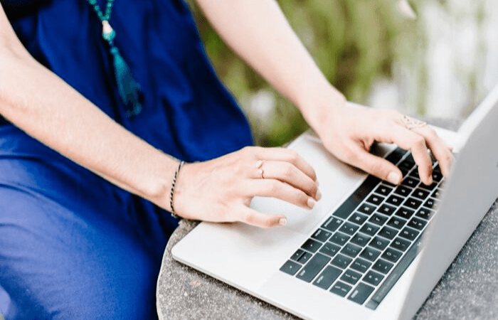 woman typing on laptop