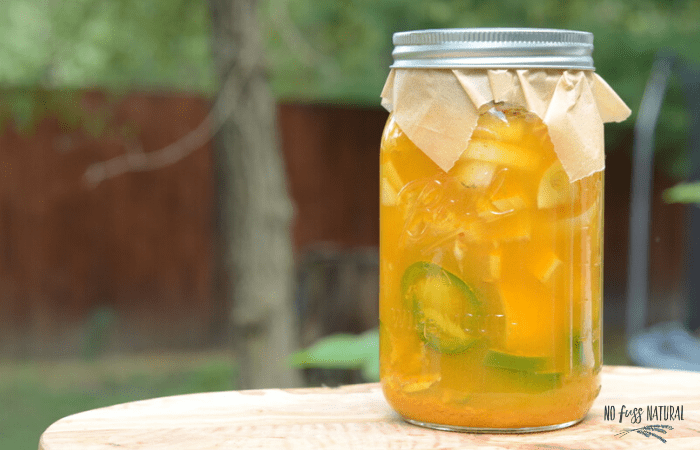 fire cider ingredients steeping in jar