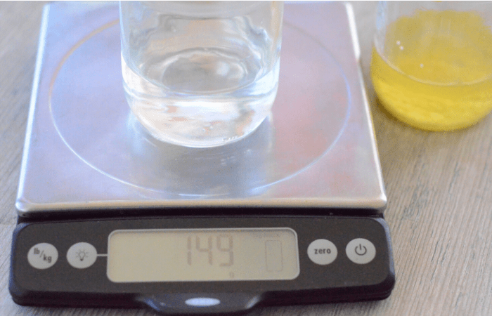 weighing ingredients for lotion on a kitchen scale